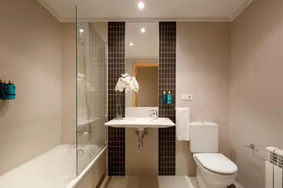 a bathroom with a toilet and a sink and a shower at Vita Homes by Upper Luxury Housing in Santiago de Compostela
