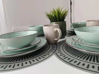 a table with plates and bowls on a table at Night Day in Padrón