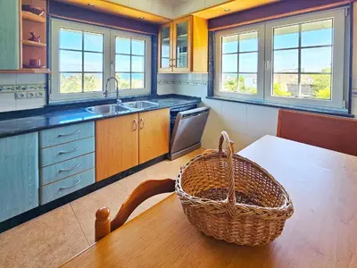 a kitchen with a table and a basket on the table at Casa Naveira vistas mar en Foz in Foz