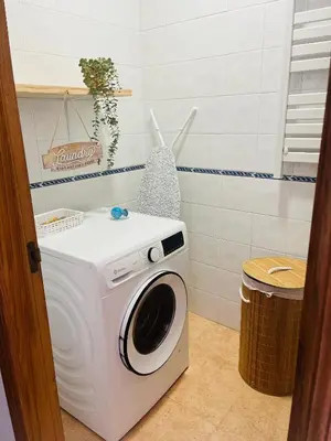 a washer and dryer in a bathroom at Casa Naveira vistas mar en Foz in Foz