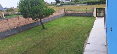 a small tree in a yard next to a fence at Casa Julia in Barreiros
