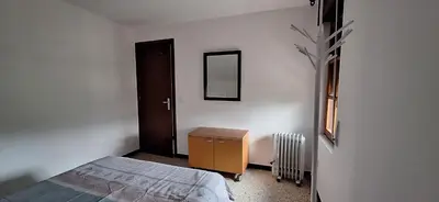 a bedroom with a bed and a mirror and a door at Casa Julia in Barreiros