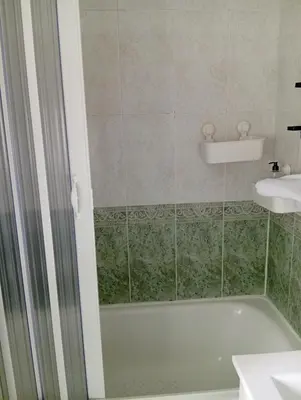 a bathroom with a bath tub and a sink at Fonteculler centro in Culleredo