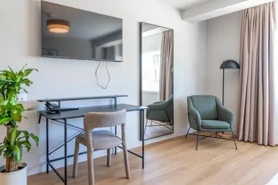 a living room with a desk and two chairs at SNÖ Porta das Fragas in A Capela