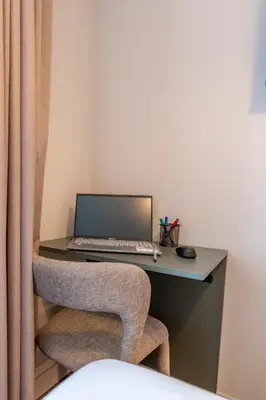 a laptop computer sitting on a desk with a chair at SNÖ Porta das Fragas in A Capela