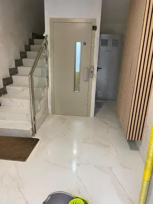 a hallway with stairs and a door with a dog bowl on the floor at Piso Bedoya in Ourense