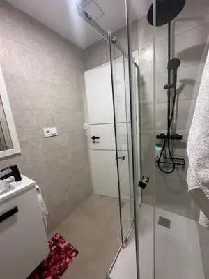 a shower with a glass door in a bathroom at Piso Bedoya in Ourense