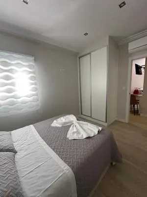 a bedroom with a bed and a light on the wall at Piso Bedoya in Ourense
