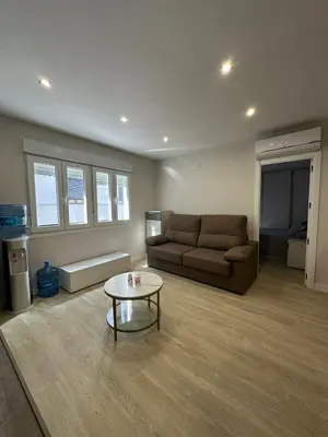 a living room with a couch and a coffee table at Piso Bedoya in Ourense