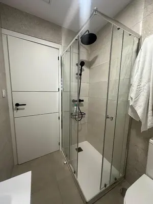 a shower with a glass door in a bathroom at Piso Bedoya in Ourense
