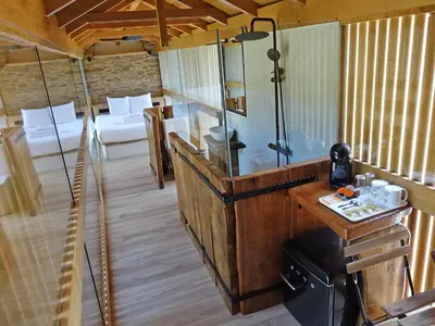 a room with a shower and a table in a room at Suit Cabozo de Rexa in Barral