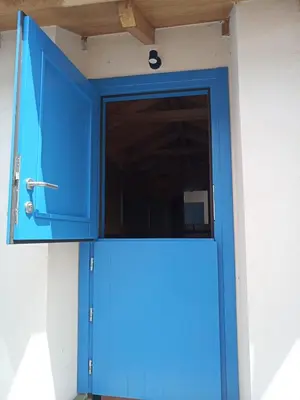 a blue door with a window in it at Suit Cabozo de Rexa in Barral