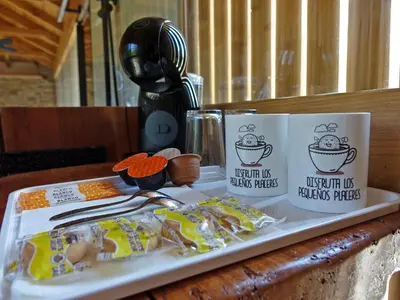 two coffee cups sitting on a table with food at Suit Cabozo de Rexa in Barral