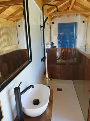 a bathroom with a sink and a shower at Suit Cabozo de Rexa in Barral