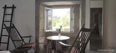 a table and chairs in a room with a window at Casa Vaz in A Estrada