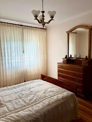 a bedroom with a bed and a dresser and a mirror at Aloe Cela in Outeiro de Rei