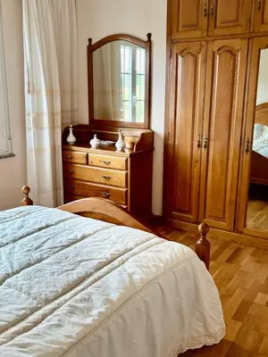 a bedroom with a dresser and a bed with a mirror at Aloe Cela in Outeiro de Rei