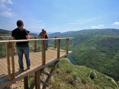two people standing on a wooden observation deck overlooking a valley at Casa Otero in Serode