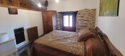 a small bedroom with a bed and a window at Casa Otero in Serode