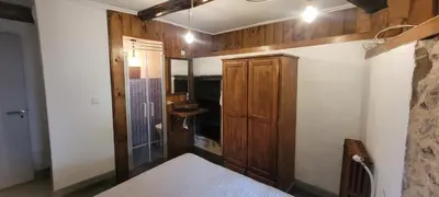 a bedroom with a bed and a sink in a room at Casa Otero in Serode