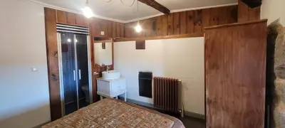 a bedroom with a bed and a sink in a room at Casa Otero in Serode