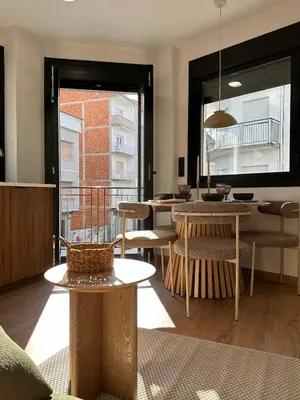a living room with tables and chairs and a window at Lemos Lar in Monforte de Lemos