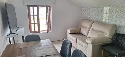 a living room with a couch and a table at Casa Julia, primera línea de playa junto a las Catedrales in San Miguel Reinante
