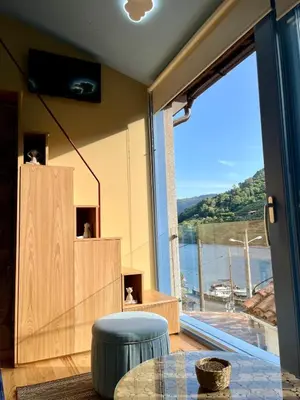 a living room with a large window and a table at Casa ATURUXIÑO in Belesar