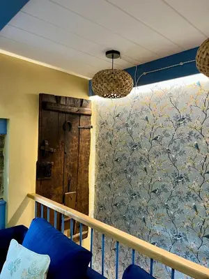 a balcony with a blue couch and a wall at Casa ATURUXIÑO in Belesar