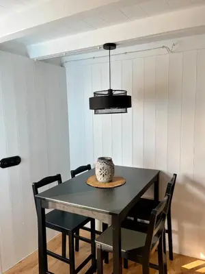 a dining room table with chairs and a pot on top at Casa ATURUXIÑO in Belesar