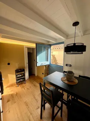 a dining room with a table and a window at Casa ATURUXIÑO in Belesar