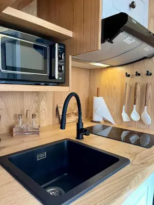 a kitchen with a sink and a microwave at Casa ATURUXIÑO in Belesar