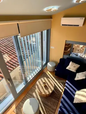 a living room with a couch and a large window at Casa ATURUXIÑO in Belesar