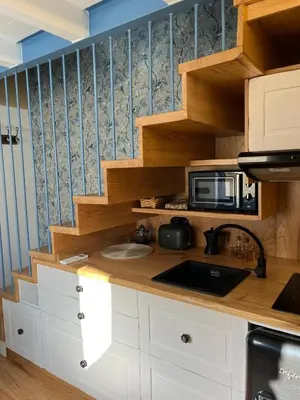 a kitchen with a counter top with a microwave at Casa ATURUXIÑO in Belesar