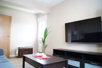 a living room with a tv and a coffee table at Fin del Camino in Santiago de Compostela