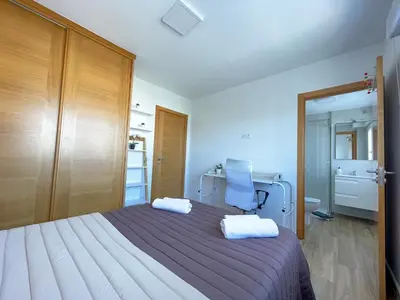 a bedroom with a bed and a chair in it at Fin del Camino in Santiago de Compostela