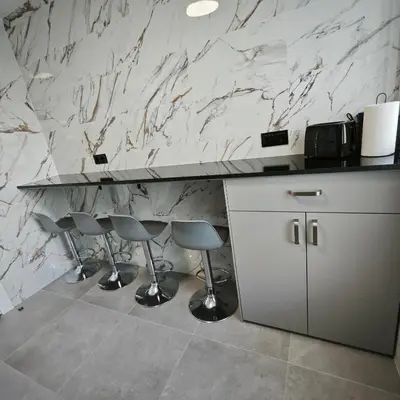 a kitchen with a counter and two stools at Manisa I in Ribadeo
