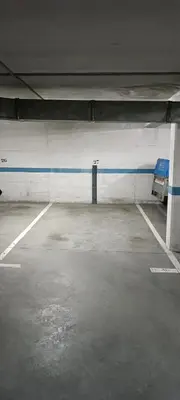 an empty parking garage with a blue and white wall at Manisa I in Ribadeo