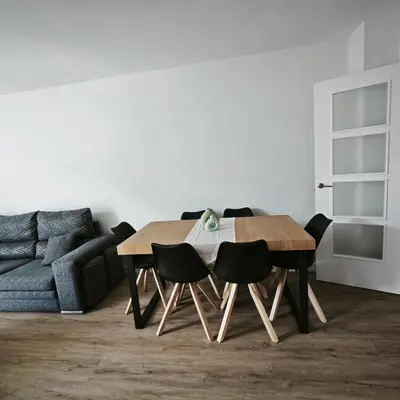 a table and chairs in a living room with a couch at Manisa I in Ribadeo