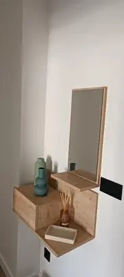 a bathroom shelf with a mirror and a sink at Manisa I in Ribadeo