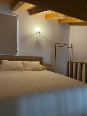 a bedroom with a bed and a light on the wall at El Granado in Cacabelos