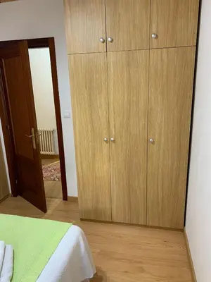 a bedroom with wooden cabinets and a bed at Casa do Carpinteiro in Crecíente