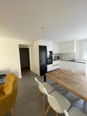 a kitchen with a large wooden table and chairs at La casita de Pepa in Caldas de Reis