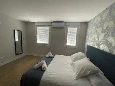 a bedroom with a bed with two towels on it at La casita de Pepa in Caldas de Reis