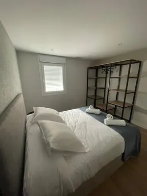 a bedroom with a large bed with two towels on it at La casita de Pepa in Caldas de Reis