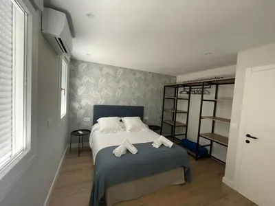 a bedroom with a bed with two towels on it at La casita de Pepa in Caldas de Reis