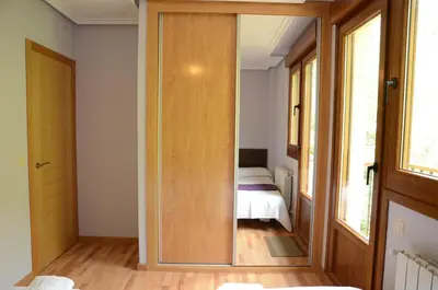 a room with a door leading to a bedroom at Apartamentos el Rincon de Limes in Cangas del Narcea
