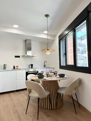 a kitchen with a table and chairs in a room at Lemos Sía in Monforte de Lemos