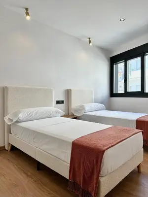 a bedroom with two beds and a window at Lemos Sía in Monforte de Lemos