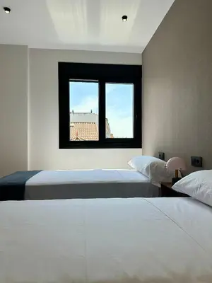 a bedroom with two beds and a window at Lemos Agra in Monforte de Lemos
